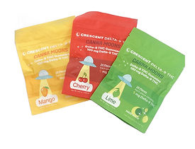 Three packs of gummies, yellow for Mango, red for Cherry, and green for Lime, of THC Gummies